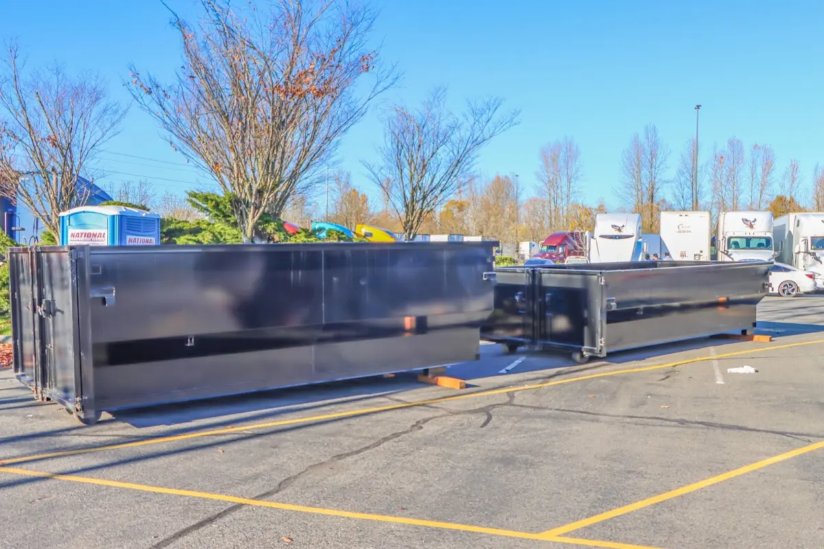 Professional dumpster rental service with roll-off container on residential driveway in Talladega